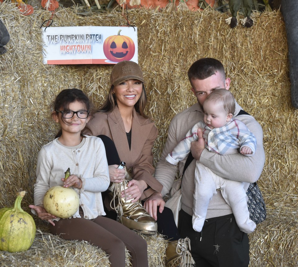 Chelsee Healey, Eddie, and their daughters pose at the Hightown Pumpkin Patch.