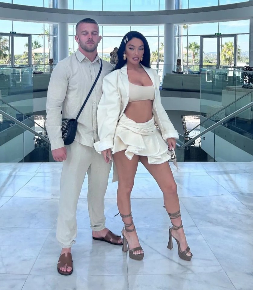 Chelsee Healey and Eddie in a large, modern building with a birthday message for Eddie.