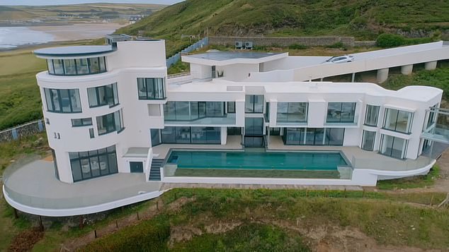 Edward Short and his wife Hazel put their life savings into building their fantasy eco-friendly home, known as Chesil Cliff House (Pictured: the completed home)