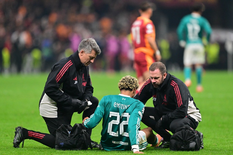 Hugo Ekitike of Liverpool receiving medical treatment on the field.