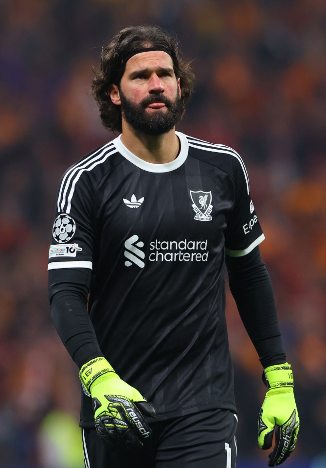 Liverpool's Alisson Becker walks off the pitch after being substituted due to an injury.