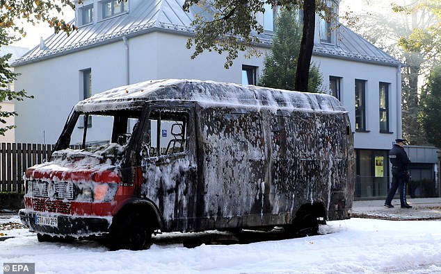 A burnt-out car at the scene after explosive devices were found in a burning house in Munich, Germany, October 1 2025