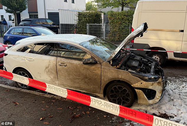 A damaged car at the scene after explosive devices were found in a burning house in Munich, Germany, October 1 2025