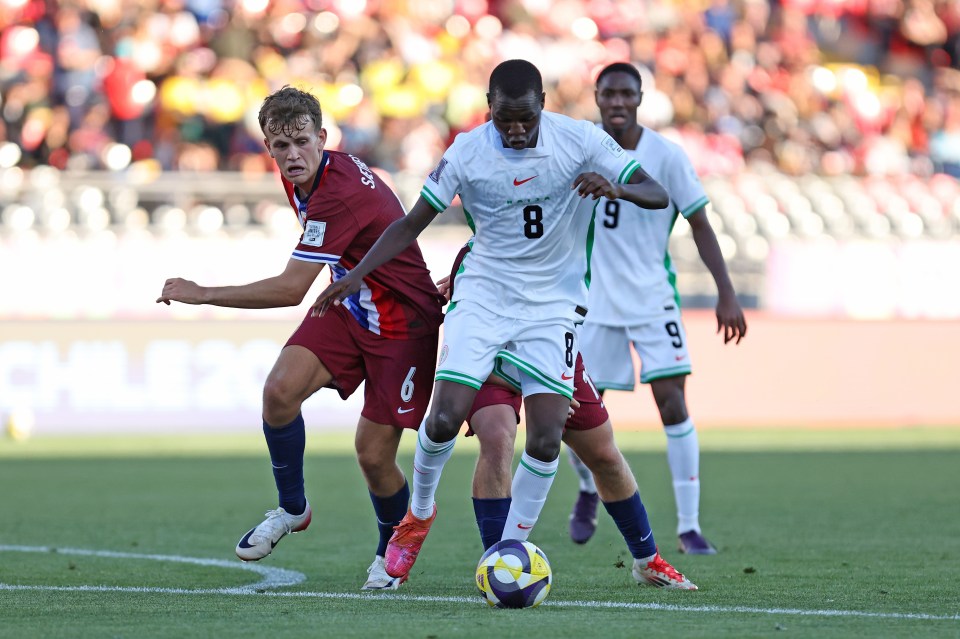 Abduljelil Kamaldeen of Nigeria runs with the ball against Bork Bang-Kittilsen and Kasper Saetherbo of Norway during a soccer match.