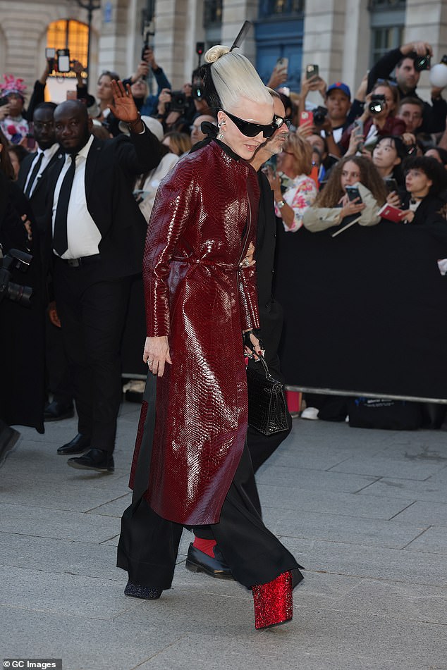 Designer and socialite Daphne Guinness displayed her own funky sense of style in a red snakeskin coat with towering platform heels