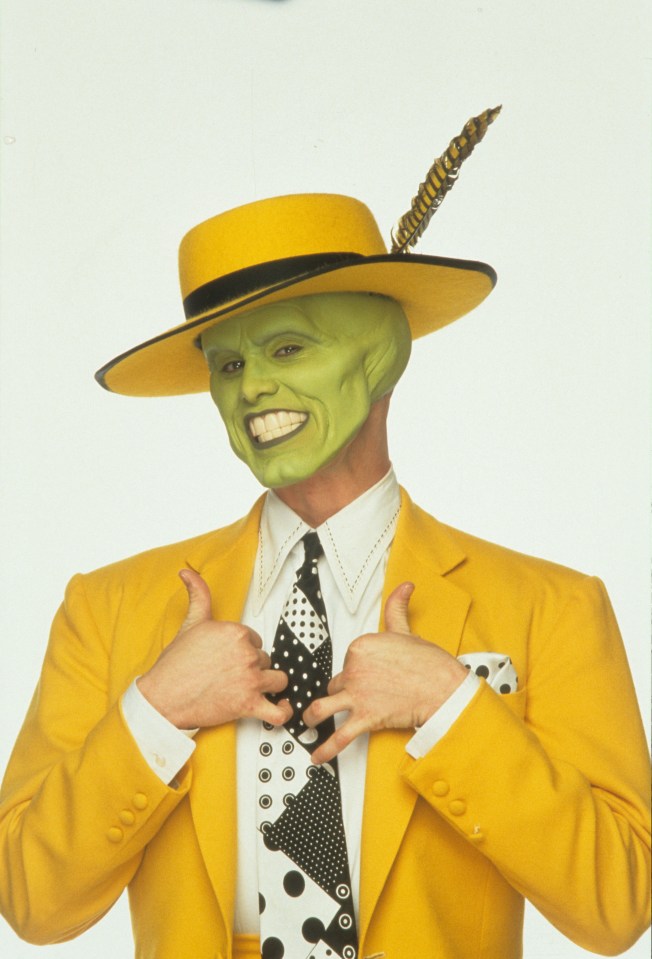 Jim Carrey as the Mask, with green face, yellow hat and suit, and a polka-dot tie, giving thumbs up.