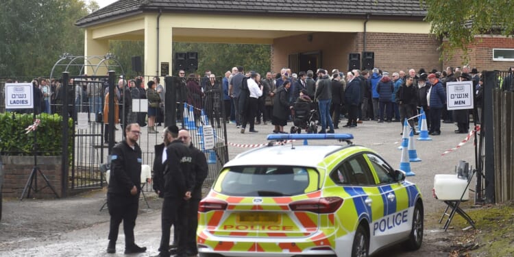 Synagogue attack victim celebrated as 'tremendously strong hero' as huge crowd of mourners attend funeral