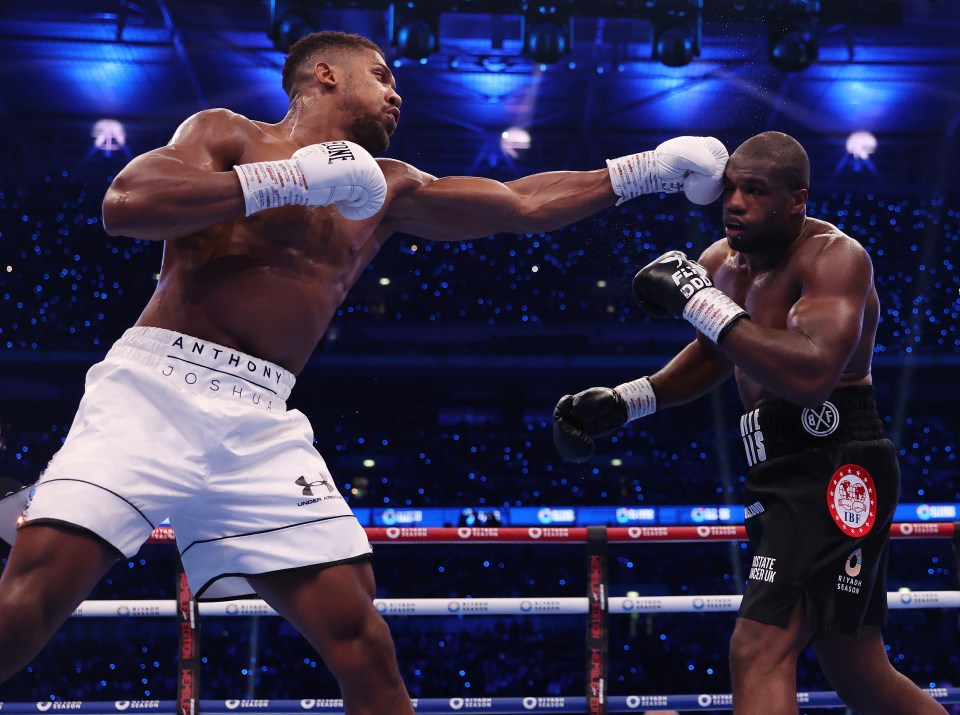 Anthony Joshua hits a left hand against Daniel Dubois during their IBF World Heavyweight Title fight.