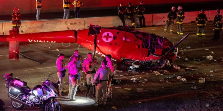 Horror moment helicopter crashes onto a freeway just feet away from terrified drivers in California leaving 3 injured