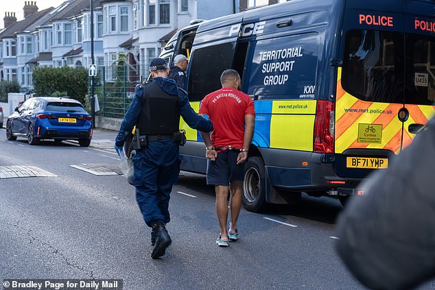 A man wearing a red football shirt, shorts and flip flops was handcuffed and led into a police van as part of a huge operation targeting those involved in the capital¿s phone theft epidemic