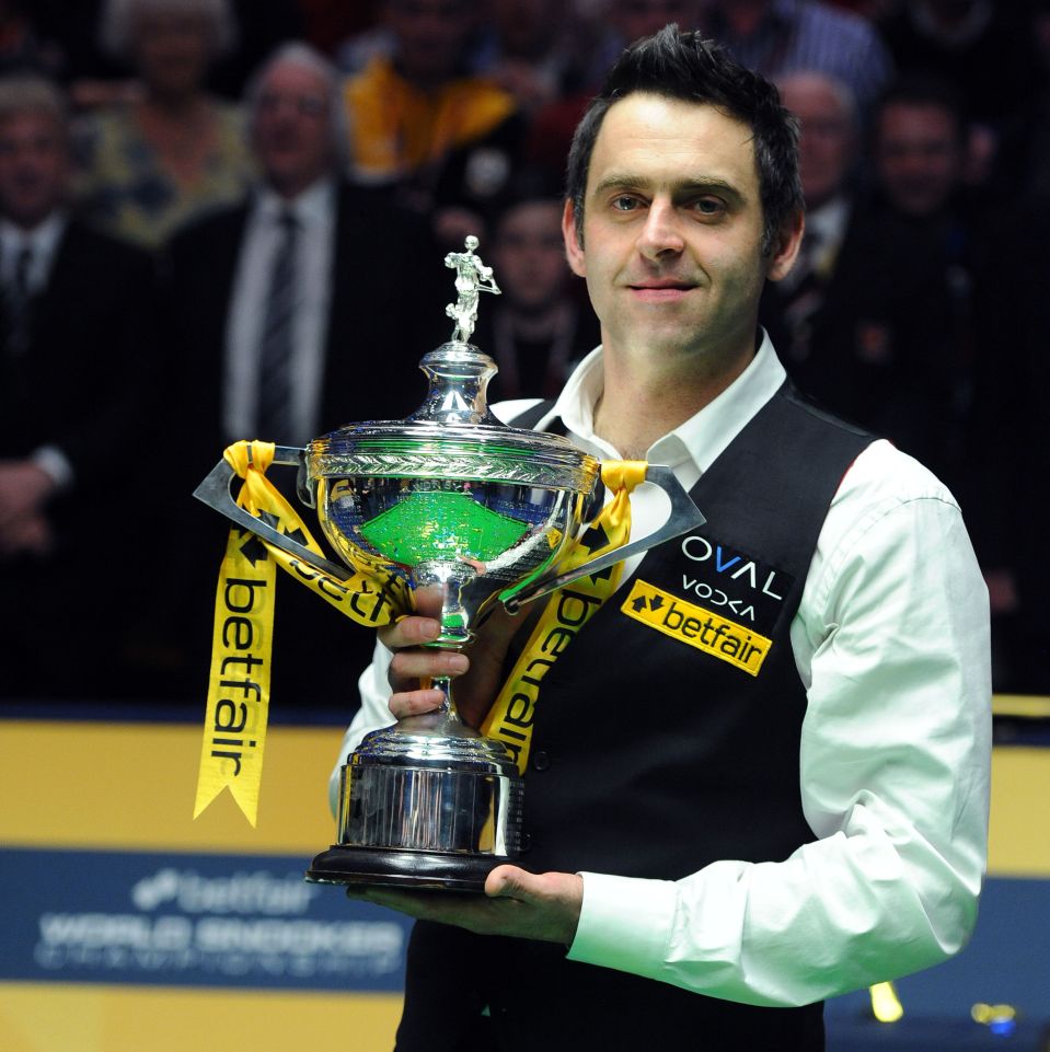 Ronnie O'Sullivan celebrates with the trophy after winning the final match during the Betfair World Championships.