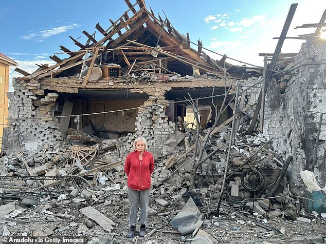 A woman stands near a collapsed building after Russian artillery strikes hit residential areas in the Kherson region of Ukraine on October 6, 2025. Image provided by the Kherson Regional Military Administration