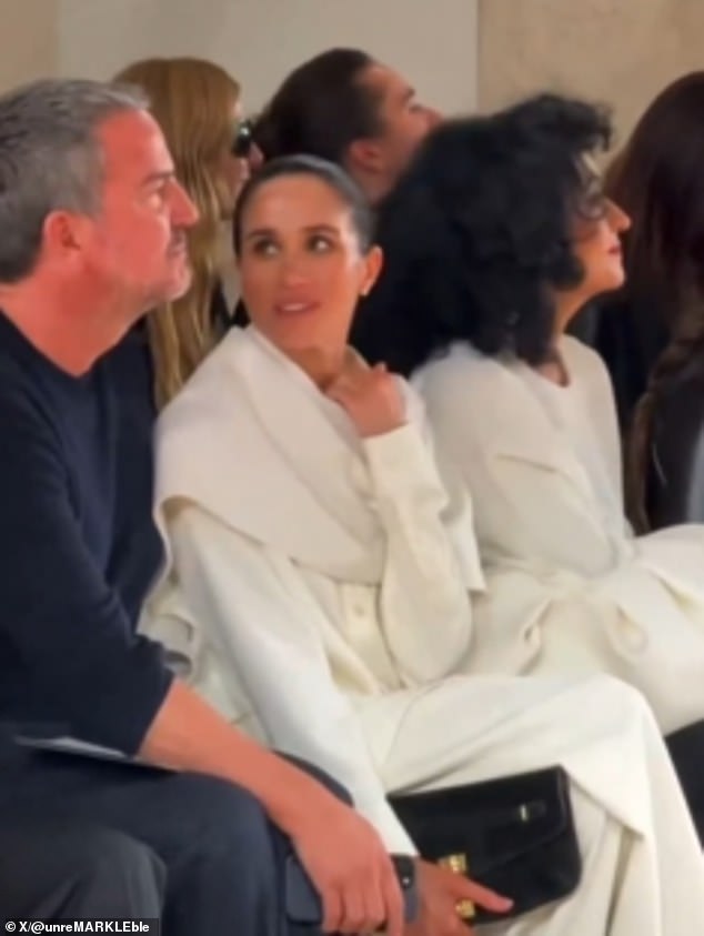 In the clip, Meghan could be seen avidly watching the fashion show from the front row, sat next to her close friend, Marcus Anderson