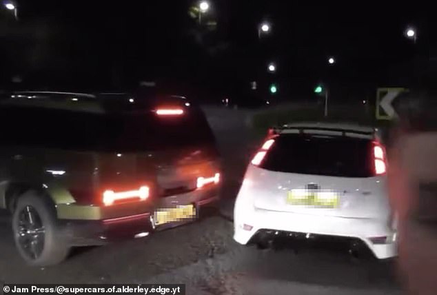 The driver slammed his brakes on to prevent what appeared to be a souped-up Ford Focus and a Kia from zooming across the roundabout - before fleeing the scene around 20 seconds later