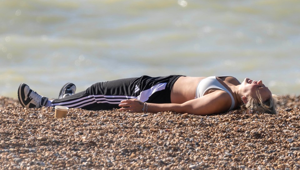 JoJo Siwa lying on Brighton beach, soaking up the autumn sun.