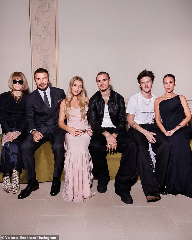 David Beckham has posted a gushing tribute to wife Victoria following her Paris Fashion Week show as the family sat united in the front row without Brooklyn alongside Cruz's girlfriend Jackie Apostel (right) and Anna Wintour (left)