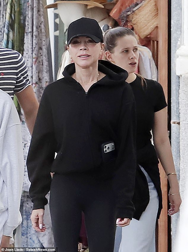 Victoria tucked her phone into her pocket during the outing