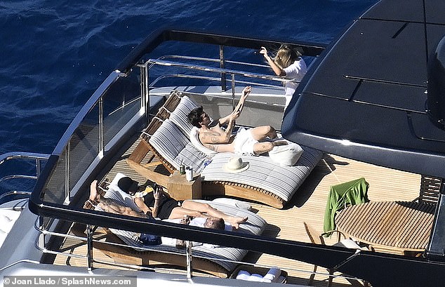 Harper chatted to her brother while her family sunbathed nearby