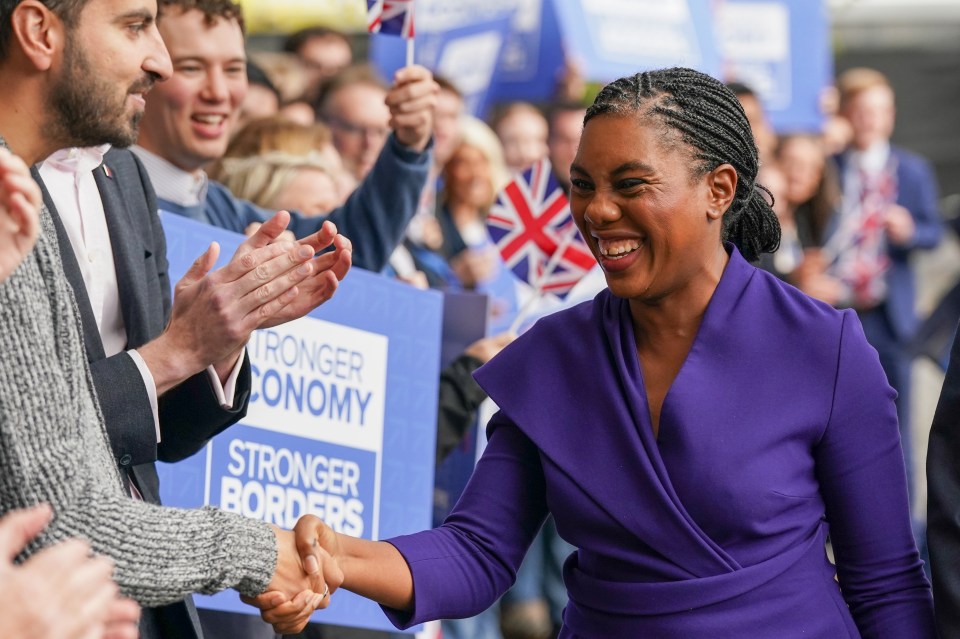 Kemi Badenoch shaking hands with a supporter at the Conservative Party Conference in Manchester.