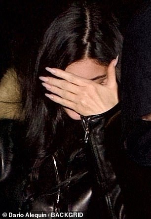 The makeup mogul flashed long pale pink nails and wore no rings on her wedding finger