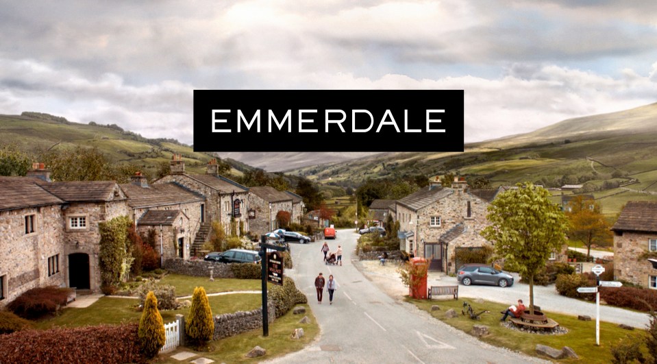 The "Emmerdale" title logo overlaid on a view of the fictional village.