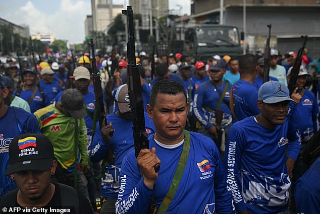 Armed civilians participate in a military deployment in support of Venezuela's presidentin Caracas in September
