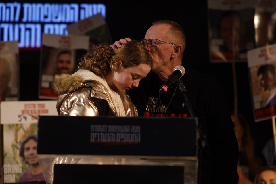 Former hostage Emily Hand and her dad Tom at a rally in Tel Aviv.