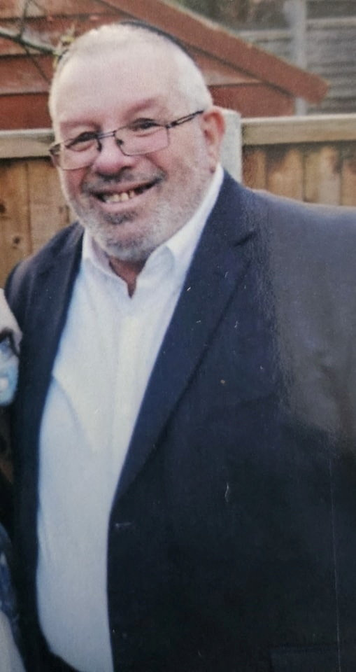 Melvin Cravitz posing for a photograph.