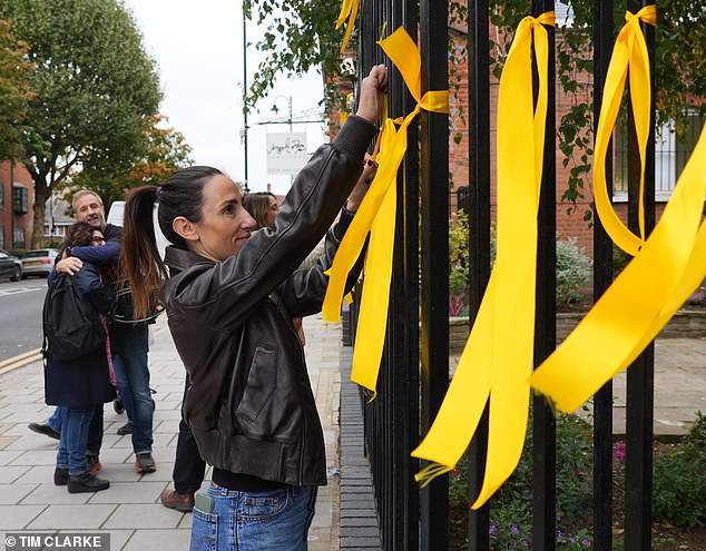 The residents retied the ribbons on Tuesday morning after they were cut down
