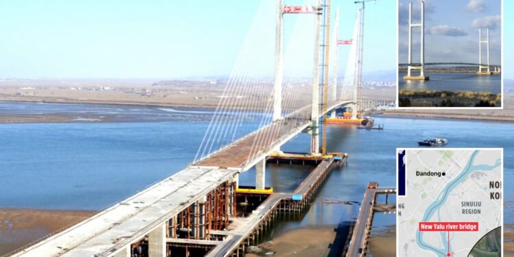 Two-mile ‘Bridge to Nowhere’ from China to North Korea abandoned so long that farmers dry crops on it could finally open