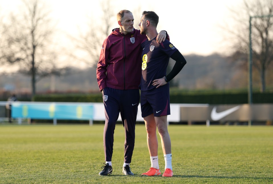 Thomas Tuchel and Jordan Henderson interacting during a training session.