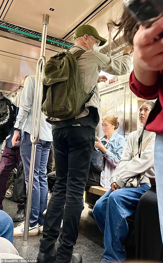 The actor, who is considered one of Hollywood¿s most down-to-earth stars, was seen standing among fellow passengers on the train in a khaki jacket layered over a dark gray sweater, black pants and an olive-green Yankees baseball cap