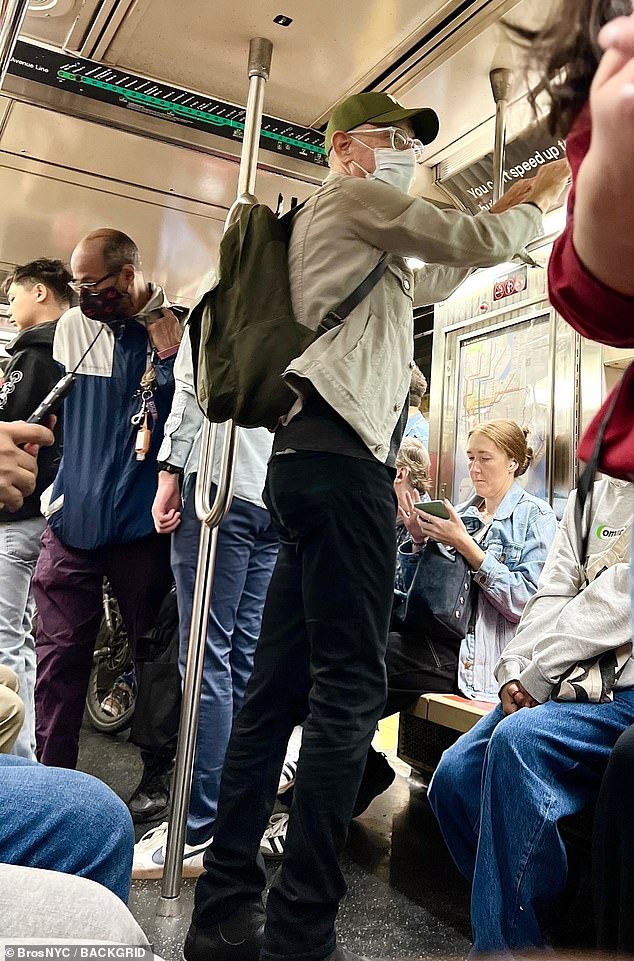 The Forrest Gump legend completed his understated look with over-ear headphones, clear glasses, and a protective face mask