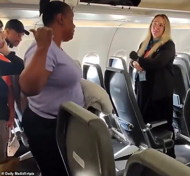 The flight attendant (right), trying to de-escalate the conflict, suggested the woman (left) step aside and wait for her daughter to make her way to the front