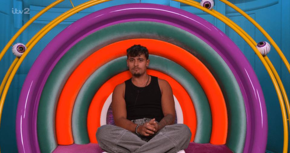 Big Brother housemate in a colorful chair.