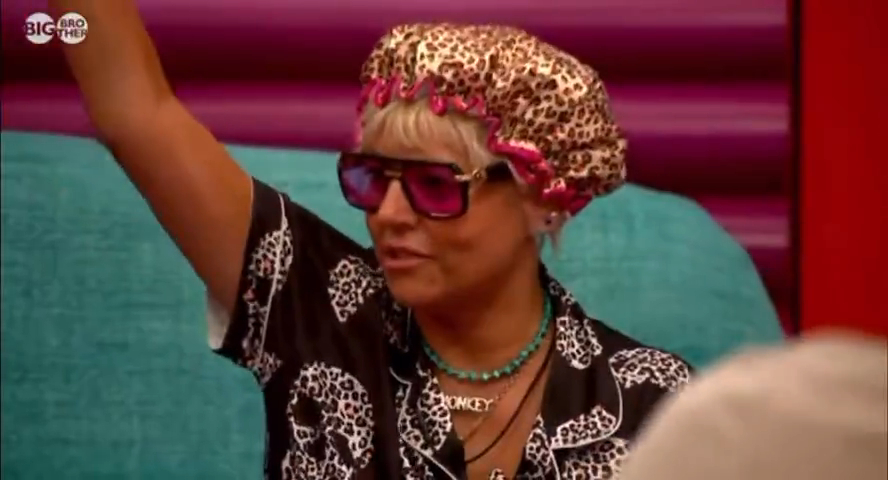 Big Brother contestant Caroline in a leopard print shower cap and sunglasses.