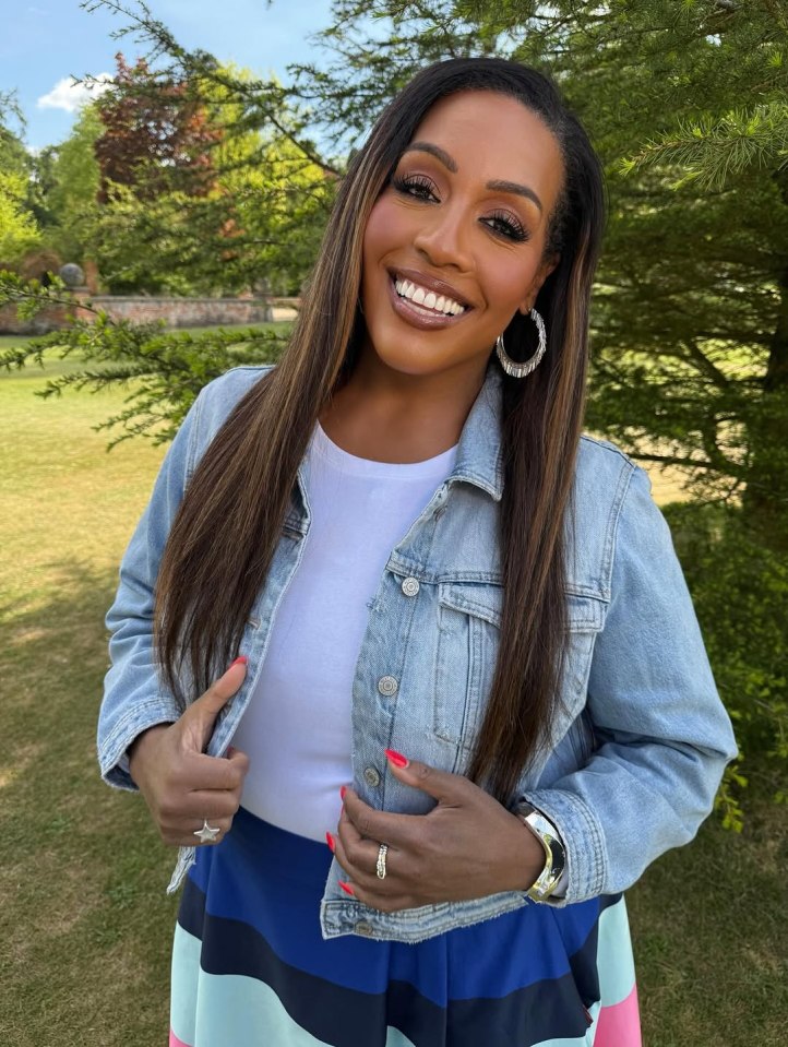 Woman wearing makeup, a denim jacket, white t-shirt, and striped skirt.