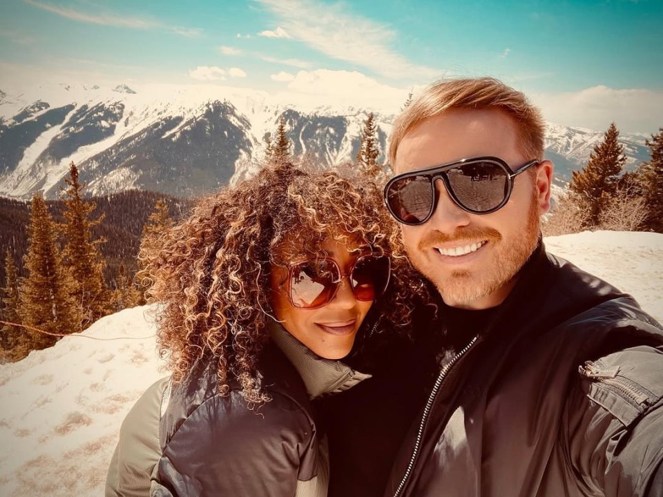 Mikey Phillips and Mel B taking a selfie with snowy mountains in the background.