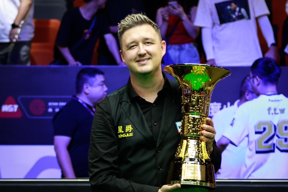 Kyren Wilson celebrating with a trophy after winning the 2024 Xi'an Grand Prix.