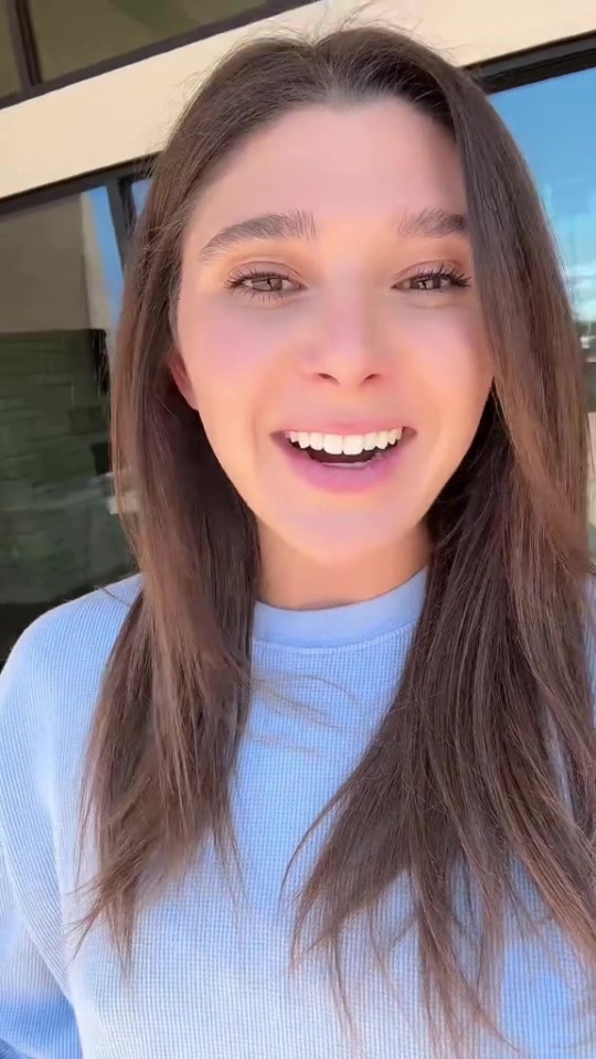 A woman smiling and looking at the camera.