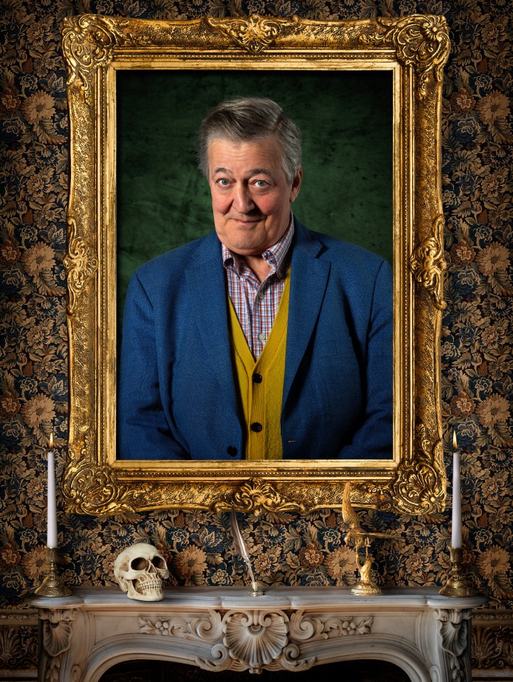 Portrait of Stephen Fry in a gold ornate frame above a fireplace with a skull, quill, and two lit candles.
