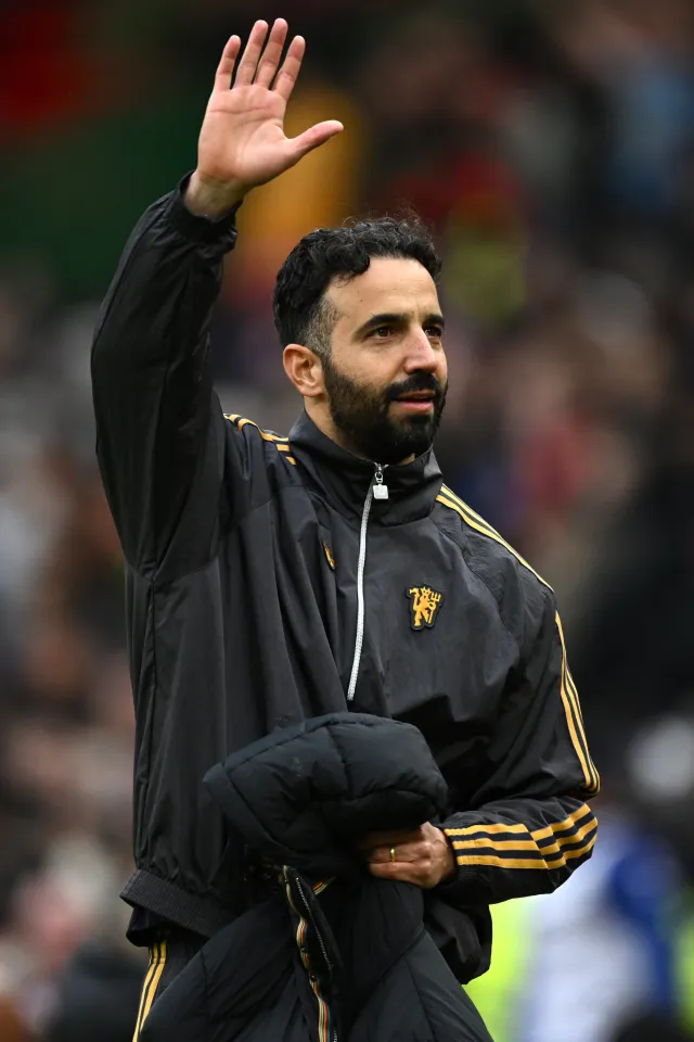 Ruben Amorim, Manager of Manchester United, acknowledging the fans with a raised hand after his team's victory.