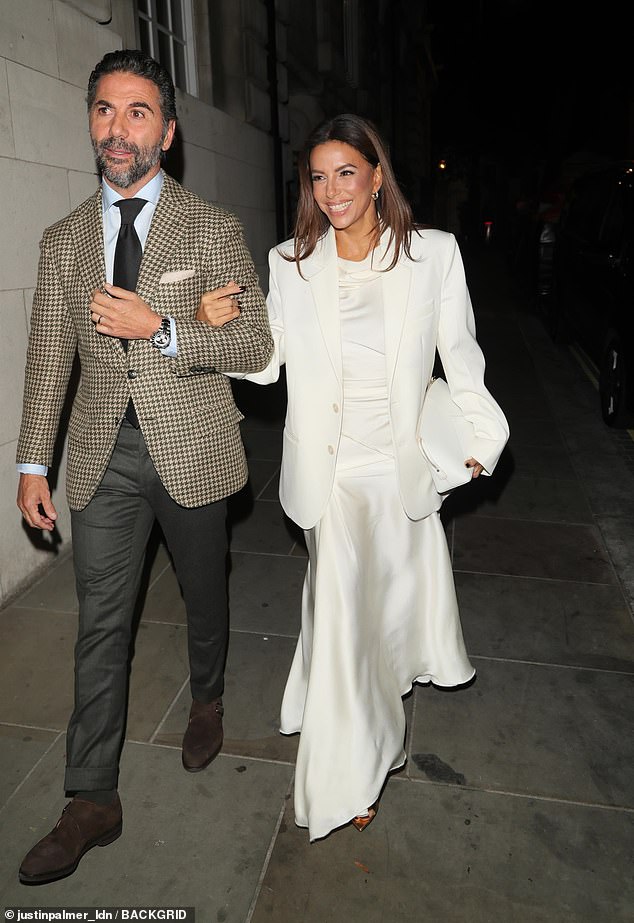 Victoria's best friend Eva Longoria - who is godmother to her daughter Harper - put on a glamorous display in a dazzling white gown as she linked arms with her husband José Bastón