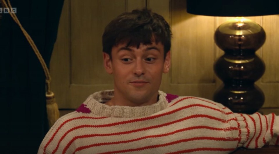 Tom Daley wearing a striped sweater.