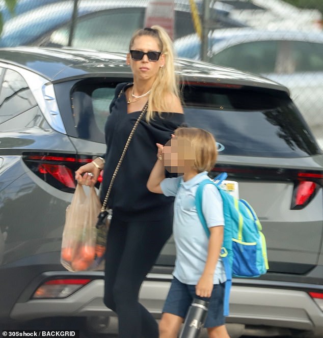 The Russian recluse was spotted trying to hide her baby bump during a rare public outing in September