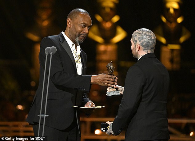 Sir Lenny presenting Jamie Lloyd with the Sir Peter Hall Award for Best Director on stage during The Olivier Awards in 2024