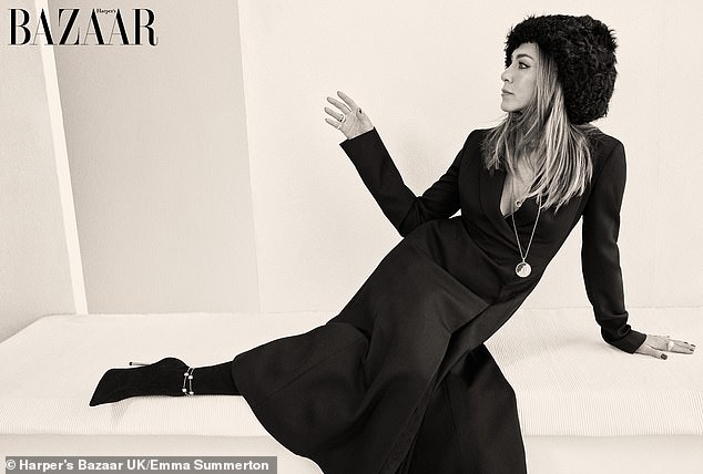 She then slipped into a plunging long sleeve top and skirt as she posed for a chic snap