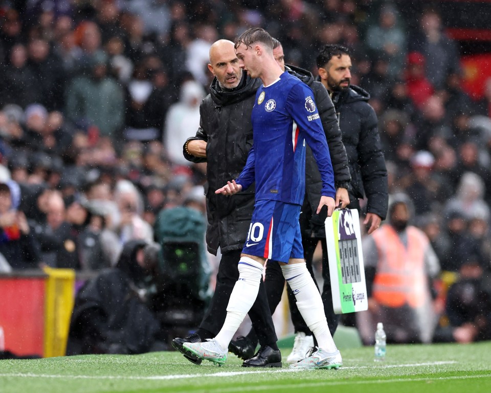 Enzo Maresca and Cole Palmer talking on the field after Palmer was substituted during a Premier League match.