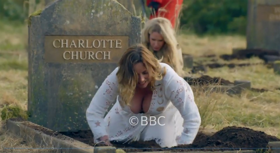 Charlotte Church digging a grave, with another person behind her.