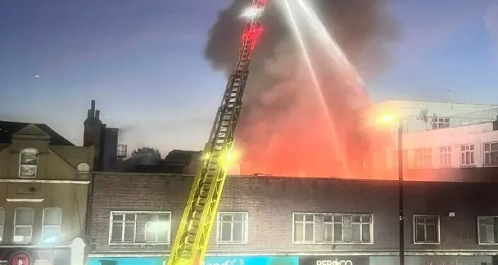 Huge blaze rips through Poundland shop on London high street sending smoke into sky with 100 firefighters at store